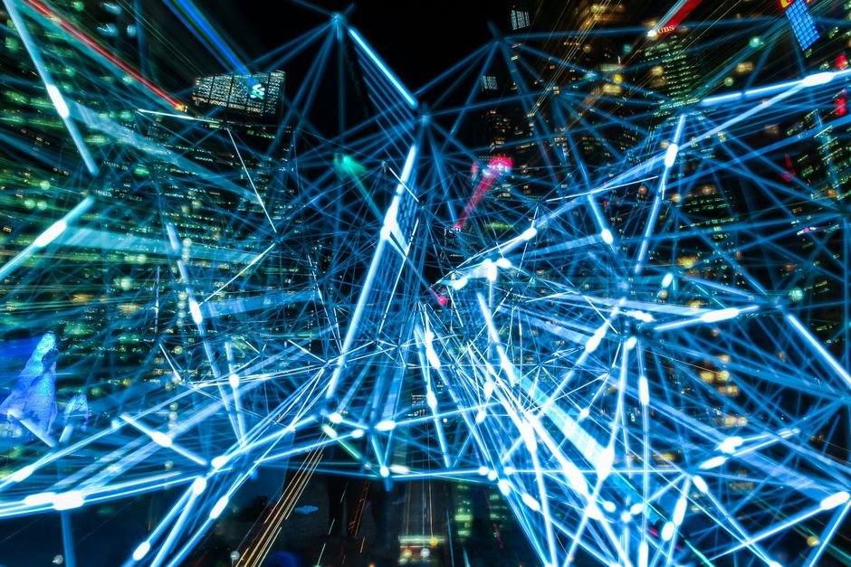 abstract blue network of light trails over a city skyline at night, representing a large AI model's neural connections