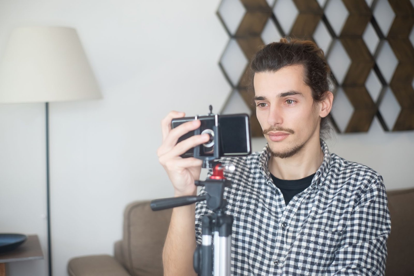 A creator filming vertical video content on a smartphone mounted on a tripod, the kind of setup used to shoot UGC ads before AI video tools enter the workflow