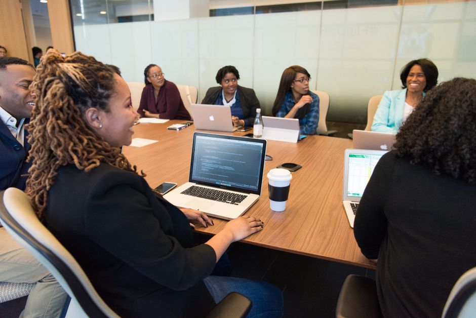 a small group of business professionals in discussion during a meeting