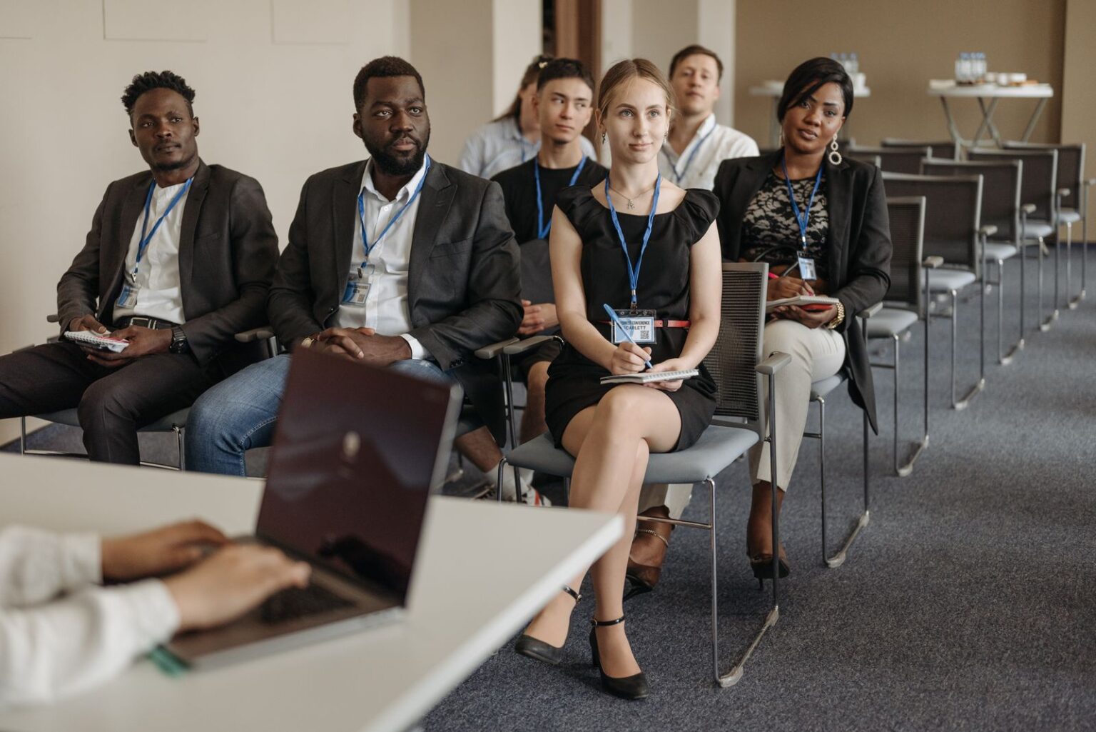 Business professionals with conference badges at a B2B event